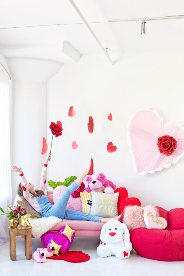 Someone sitting on a couch with a bunch of pillows